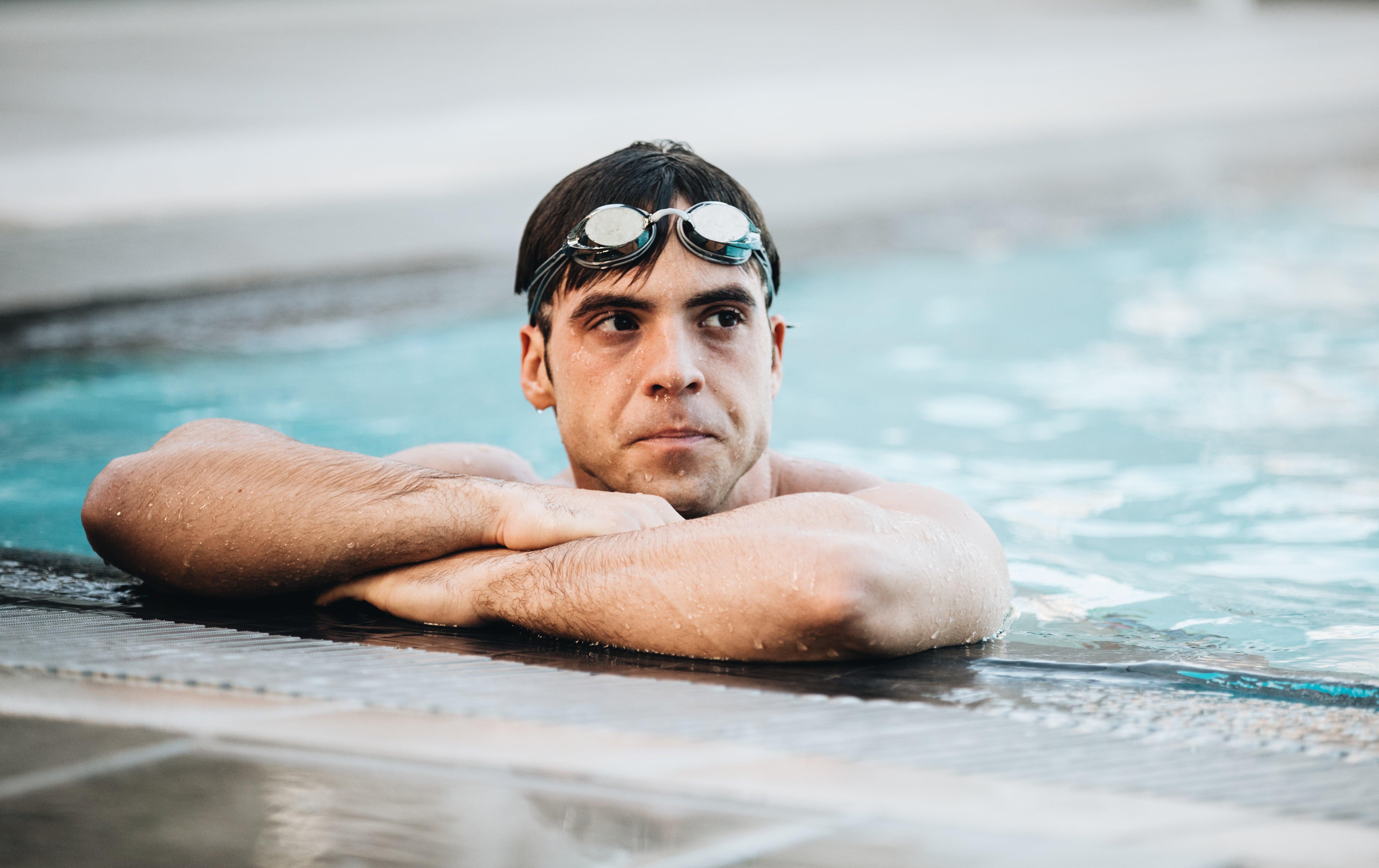 man in pool - Should You Workout With DOMS